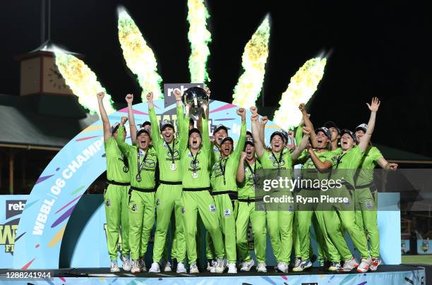 Rachael Haynes of the Thunder lifts the trophy as the Thunder celebrate victory during the Women's Big Bash League Final between the Melbourne Stars...