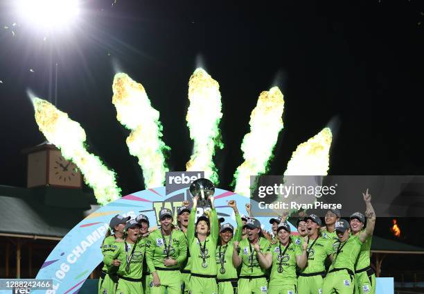 Rachael Haynes of the Thunder lifts the trophy as the Thunder celebrate victory during the Women's Big Bash League Final between the Melbourne Stars...