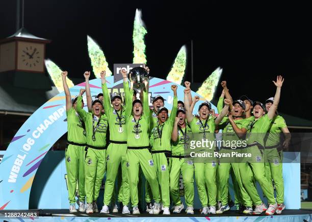 Rachael Haynes of the Thunder lifts the trophy as the Thunder celebrate victory during the Women's Big Bash League Final between the Melbourne Stars...