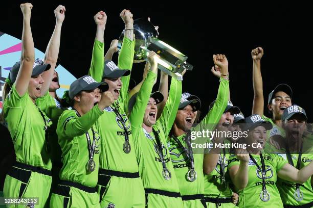 Rachael Haynes of the Thunder lifts the trophy as the Thunder celebrate victory during the Women's Big Bash League Final between the Melbourne Stars...