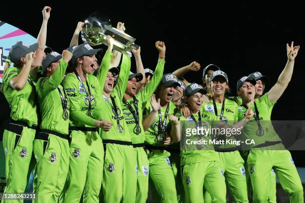 Rachael Haynes of the Thunder lifts the trophy as the Thunder celebrate victory during the Women's Big Bash League Final between the Melbourne Stars...