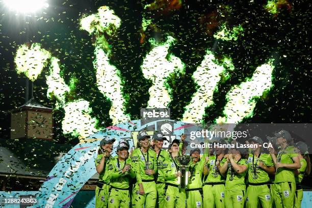 Rachael Haynes of the Thunder lifts the trophy as the Thunder celebrate victory during the Women's Big Bash League Final between the Melbourne Stars...