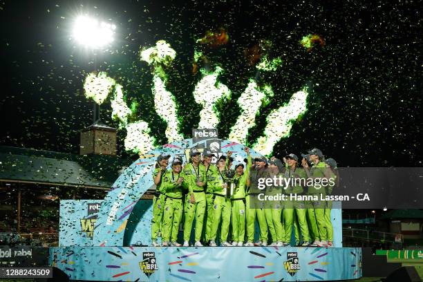 Rachael Haynes of the Thunder lifts the trophy as the Thunder celebrate victory during the Women's Big Bash League Final between the Melbourne Stars...