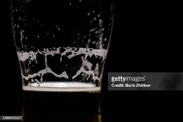 partially empty beer glass. - empty beer glass stock pictures, royalty-free photos & images