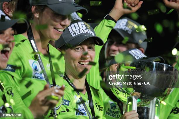 Rachael Haynes of the Thunder lifts the trophy as the Thunder celebrate victory during the Women's Big Bash League Final between the Melbourne Stars...