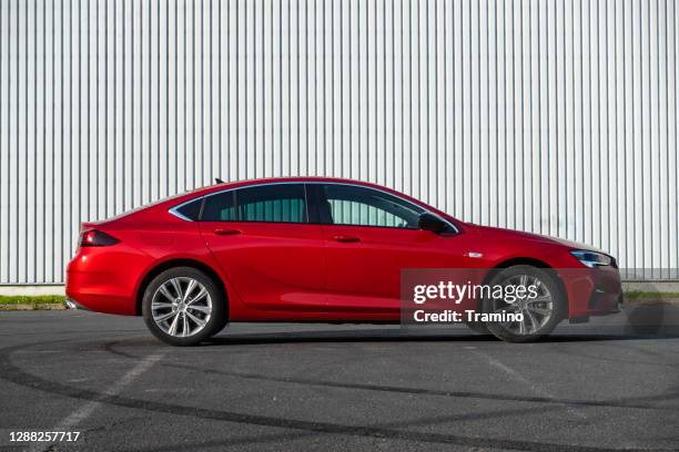 red liftback opel insignia grand sport on a parking - opel stock pictures, royalty-free photos & images