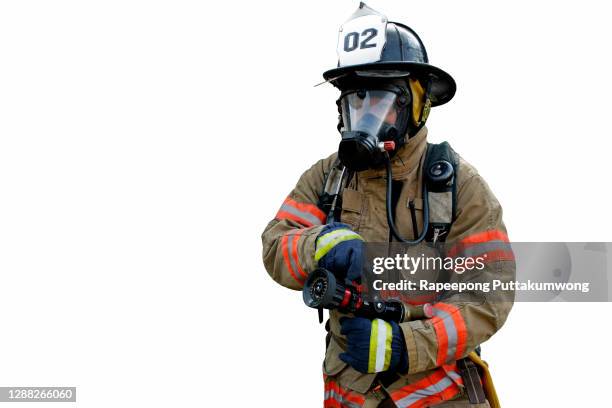 firefighter holding fire hose. fire prevention and extinguishing concept. - brandslang stockfoto's en -beelden