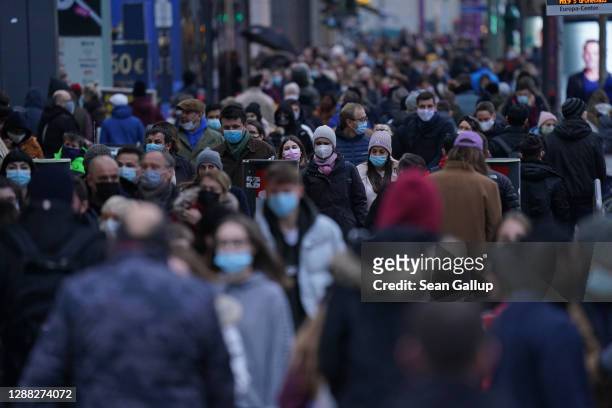 Shoppers crowd Tauntzienstrasse shopping street on Black Friday weekend during the second wave of the coronavirus pandemic on November 28, 2020 in...