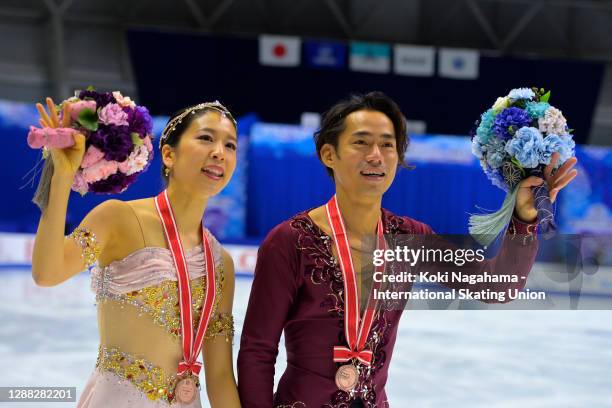 Bronze medalists Kana Muramoto and Daisuke Takahashi of Japan do a lap of honour after the medals ceremony of the Ice Dance on day 2 of the ISU Grand...