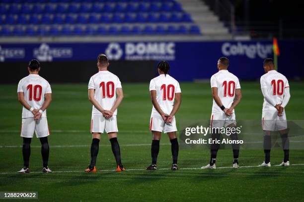 Sevilla players wear shirts with the number ten in memory of Diego Maradona prior to the La Liga Santander match between SD Huesca and Sevilla FC at...