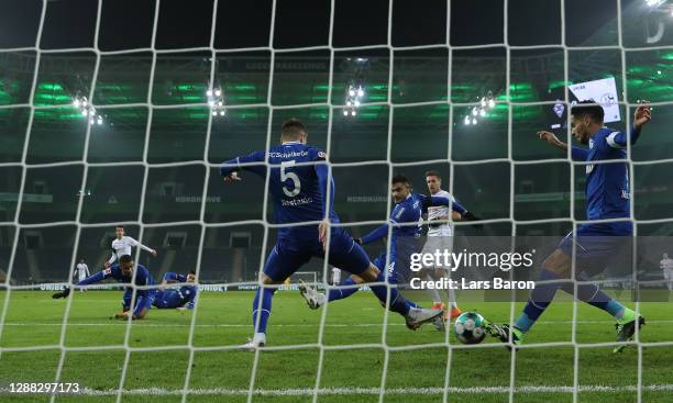 Matija Nastasic of FC Schalke 04, and Omar Mascarell of FC Schalke 04 attempt to clear the ball as Florian Neuhaus of Borussia Monchengladbach scores...