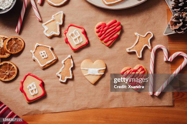 baking christmas cookies at home during pandemic - decorating cookies stock pictures, royalty-free photos & images