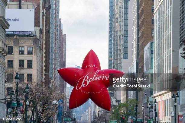 symbol of macy's believe star balloon appears on the 34th street and 6th avenue - virtual thanksgiving stock pictures, royalty-free photos & images
