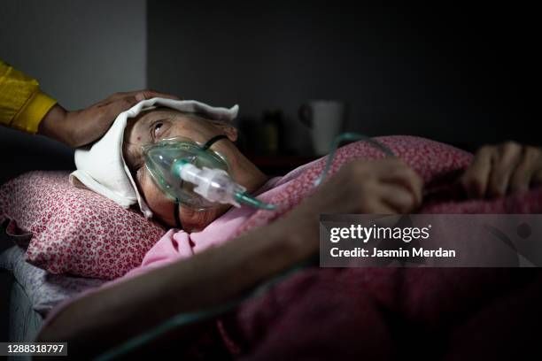 senior sick woman on bed with respiratory ventilator - patient on ventilator stock pictures, royalty-free photos & images