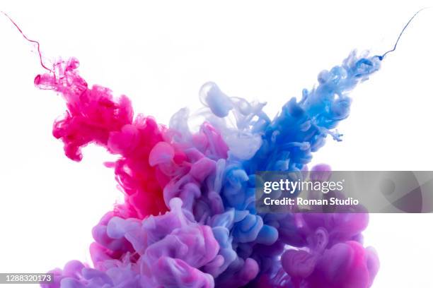 colorful ink swirling in water. - color explosion water stock pictures, royalty-free photos & images