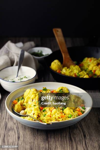 healthy vegan biryani with cashew and coconut yoghurt - cauliflower stock pictures, royalty-free photos & images
