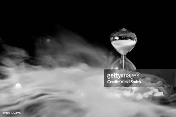 use of creative effects with dry ice fog and a hour glass timer - dry ice stock pictures, royalty-free photos & images