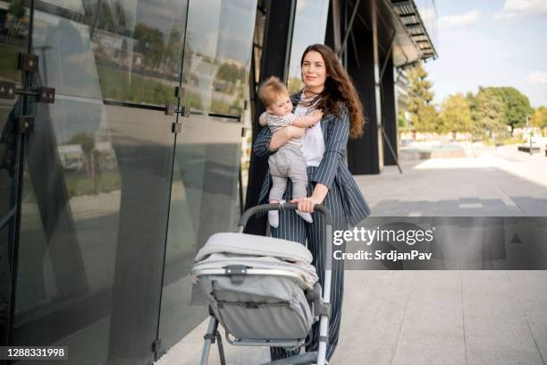 confident mother and her baby having a walk - super mom stock pictures, royalty-free photos & images