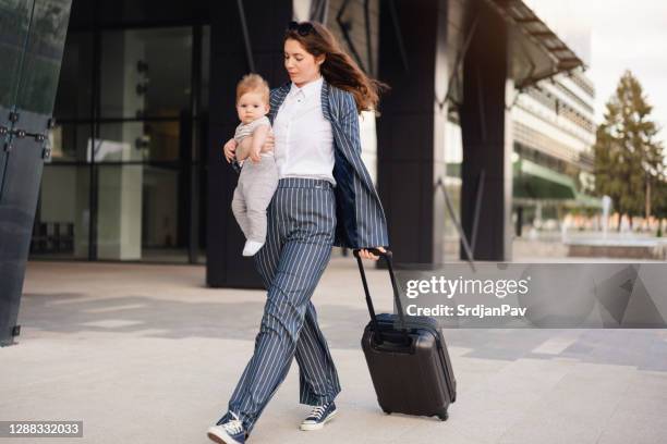 business trip of a young mother - super mom stock pictures, royalty-free photos & images