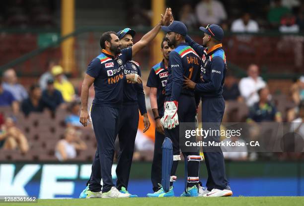 Mohammed Shami and Virat Kohli of India celebrate getting the wicket of Aaron Finch of Australia during game two of the One Day International series...