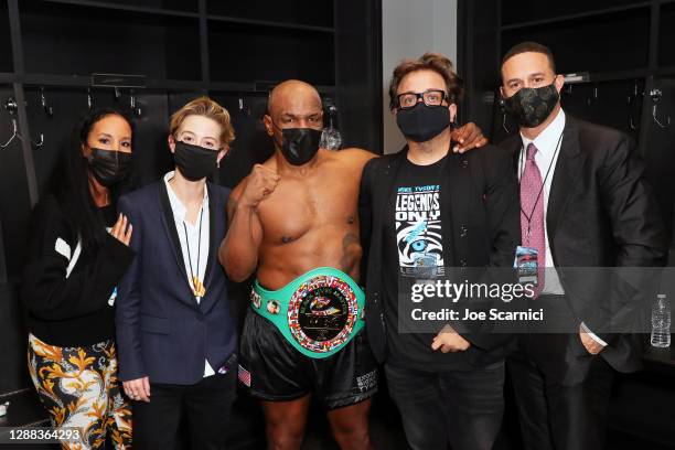 Kiki Tyson, Sophie Watts, Mike Tyson, John Ryan, and Azheem Spicer pose in the locker room during Mike Tyson vs Roy Jones Jr. Presented by Triller at...