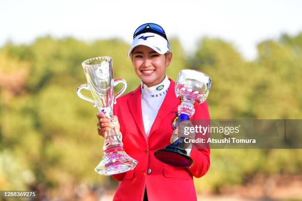 Erika Hara of Japan poses with the trophies after winning the tournament following the final round of the JLPGA Tour Championship Ricoh Cup at the...