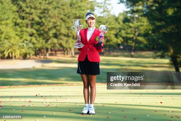 Erika Hara of Japan poses with the trophies after winning the tournament following the final round of the JLPGA Tour Championship Ricoh Cup at the...