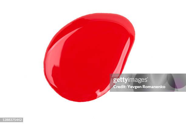 spilled red nail polish on white background - lacquered stock pictures, royalty-free photos & images