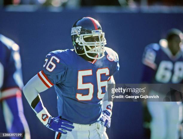 Linebacker Lawrence Taylor of the New York Giants looks on from the field during a National Football League game at Giants Stadium in December 1986...