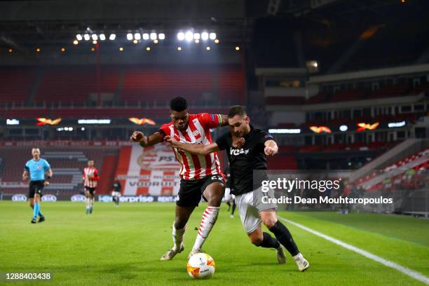 Denzel Dumfries of PSV battles for the ball with Andrija Zivkovic of PAOK during the UEFA Europa League Group E stage match between PSV Eindhoven and...