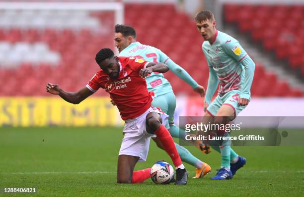 Sammy Ameobi of Nottingham Forest is challenged by Connor Roberts and Jay Fulton of Swansea City during the Sky Bet Championship match between...