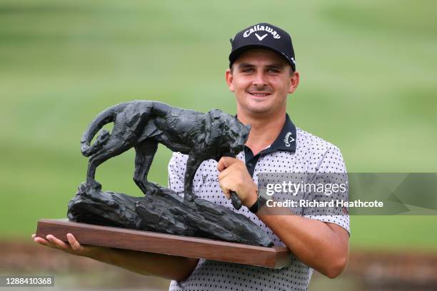 Christiaan Bezuidenhout of South Africa celebrates with the trophy following victory in the final round of the Alfred Dunhill Championship at Leopard...