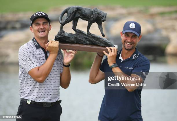 Christiaan Bezuidenhout of South Africa and caddie Johan Swanepoel pose with the trophy after winning the Alfred Dunhill Championship at Leopard...
