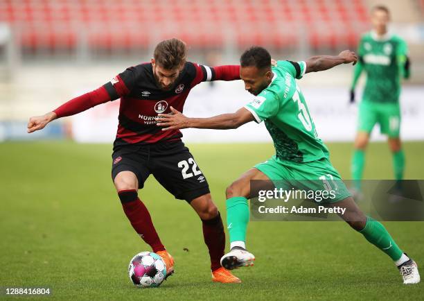 Enrico Valentini of 1. FC Nuernberg is challenged by Julian Green of SpVgg Greuther Fuerth during the Second Bundesliga match between 1. FC Nürnberg...