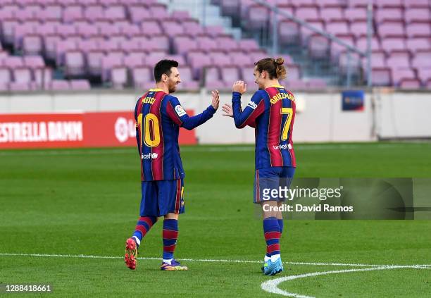 Lionel Messi celebrates with team mate Antoine Griezmann of Barcelona after their sides first goal scored by Martin Braithwaite during the La Liga...