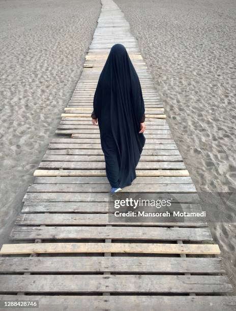 muslim arab woman is walking by hijab - caspian sea city stock pictures, royalty-free photos & images