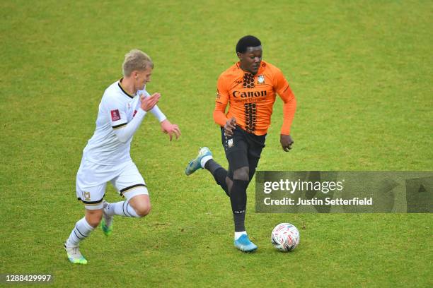 Ephron Mason-Clark of Barnet battles for possession with Lasse Sorensen of Milton Keynes Dons during the Emirates FA Cup Second Round match between...