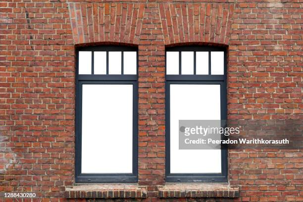 beautiful old rough brick wall and windows with black frame and isolated white empty space. - brick building exterior stock pictures, royalty-free photos & images