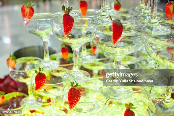 champagne pyramid tower with strawberries - champagne fountain stockfoto's en -beelden