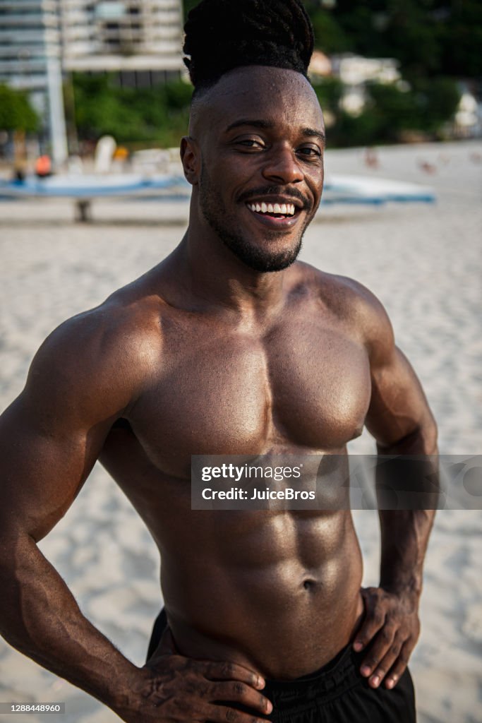 Handsome brazilian shirtless sportsman with headphones