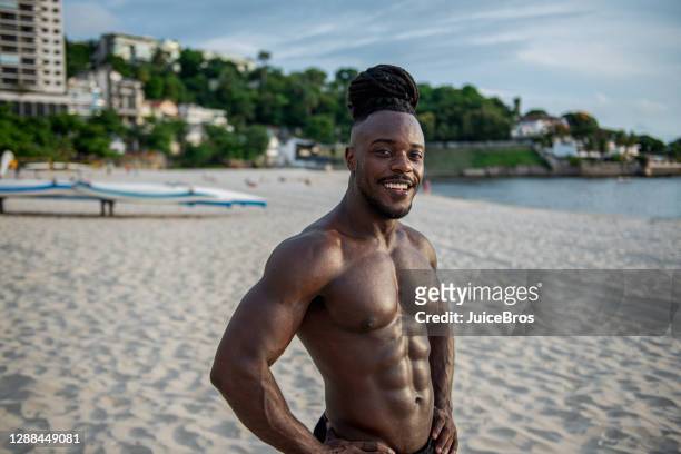 handsome brazilian shirtless sportsman with headphones - hunky guy on beach stock pictures, royalty-free photos & images