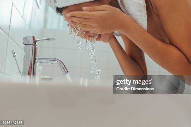 clean water is all you need - washing face stock pictures, royalty-free photos & images