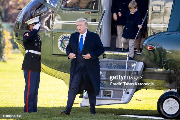 President Donald Trump, followed by his grandchildren, Arabella Kushner, Theodore Kushner, and Joseph Kushner get off Marine One on the south lawn of...