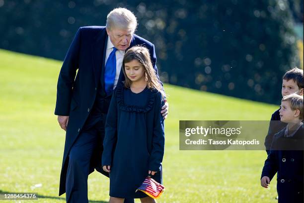 President Donald Trump, followed by his grandchildren, Arabella Kushner, Theodore Kushner, and Joseph Kushner get off Marine One on the south lawn of...