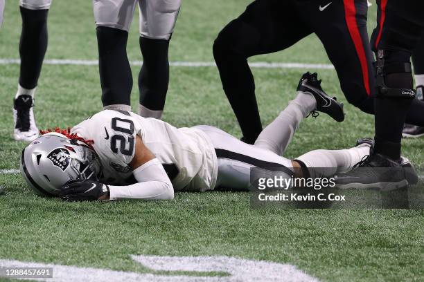 Damon Arnette of the Las Vegas Raiders lays on the field after a the opening kickoff against the Atlanta Falcons at Mercedes-Benz Stadium on November...