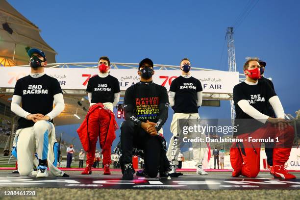 Nicholas Latifi of Canada and Williams, Lewis Hamilton of Great Britain and Mercedes GP and Sebastian Vettel of Germany and Ferrari kneel as Daniil...