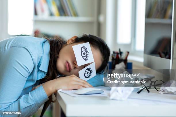 empresaria cansada siesta en su escritorio - mujer cansada fotografías e imágenes de stock
