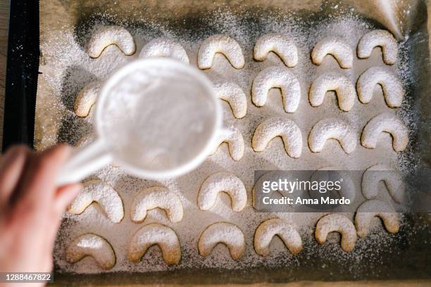 adding sugar onto christmas cookies - icing sugar stock pictures, royalty-free photos & images