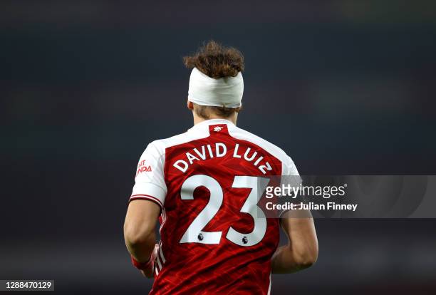 David Luiz of Arsenal wears a bandage after a colliding with Raul Jimenez of Wolverhampton Wanderers during the Premier League match between Arsenal...