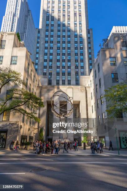 rockefeller center buildings and atlas statue as seen from 5th avenue, new york city. - atlas statue stock pictures, royalty-free photos & images